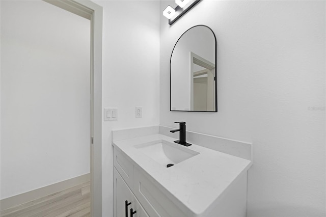 bathroom with vanity and wood-type flooring