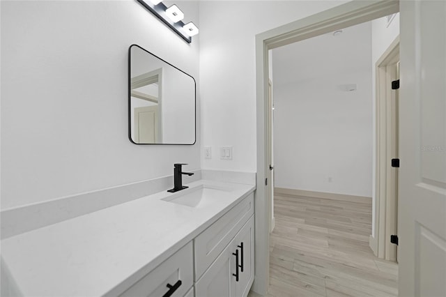 bathroom featuring hardwood / wood-style floors and vanity