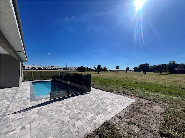 view of pool featuring a lawn and a patio