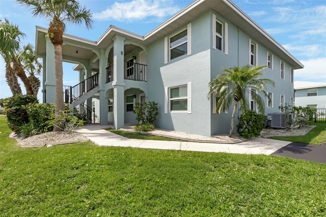 exterior space featuring central AC and a yard