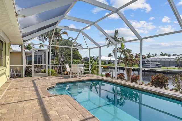 view of swimming pool with a water view, a patio, and glass enclosure