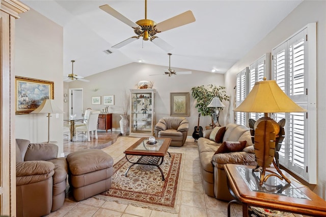 living room featuring light tile patterned floors, high vaulted ceiling, and visible vents