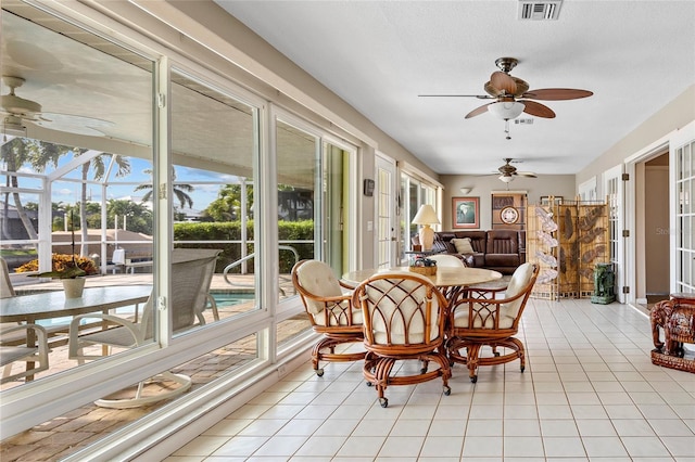 sunroom / solarium featuring ceiling fan and visible vents