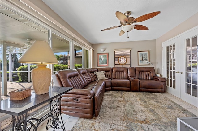 tiled living room featuring french doors and ceiling fan