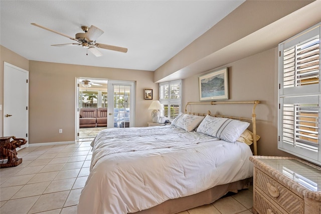 bedroom featuring a ceiling fan, lofted ceiling, baseboards, and light tile patterned floors