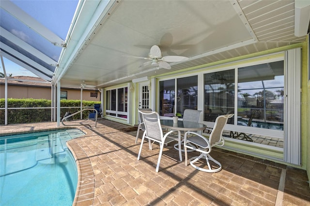 outdoor pool featuring a lanai, a patio area, outdoor dining area, and a ceiling fan