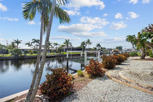 water view with a dock, boat lift, and a residential view