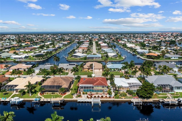 drone / aerial view with a water view and a residential view