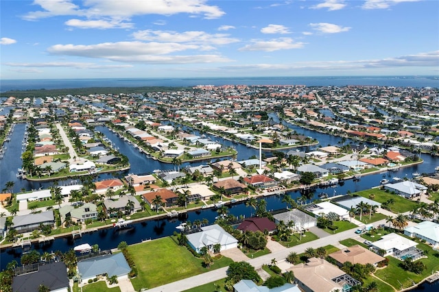 drone / aerial view with a residential view and a water view