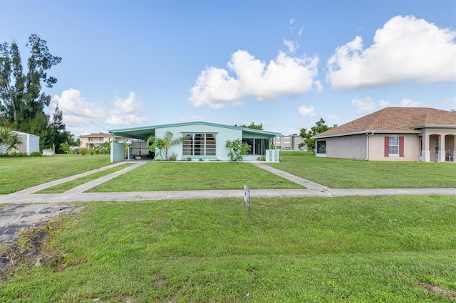 view of front of home with a front lawn and a carport