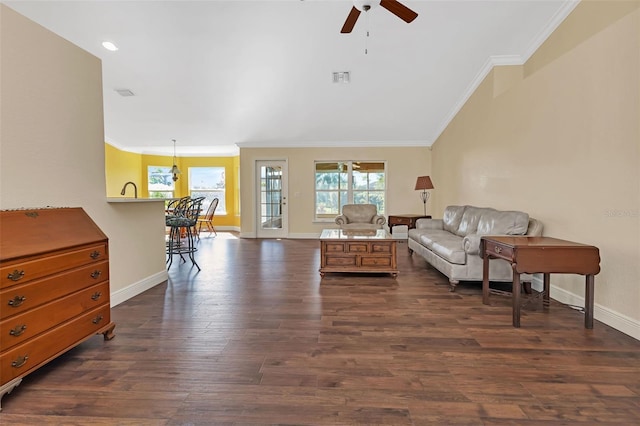 living room featuring dark hardwood / wood-style flooring, ornamental molding, and ceiling fan