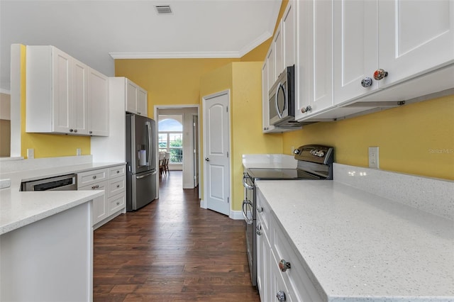 kitchen with ornamental molding, appliances with stainless steel finishes, white cabinets, and light stone counters