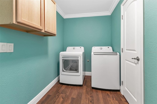 clothes washing area with cabinets, crown molding, separate washer and dryer, and dark wood-type flooring