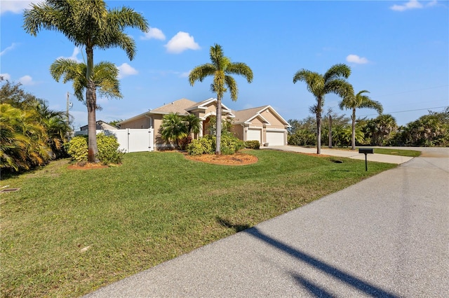 view of front of property featuring a garage and a front lawn