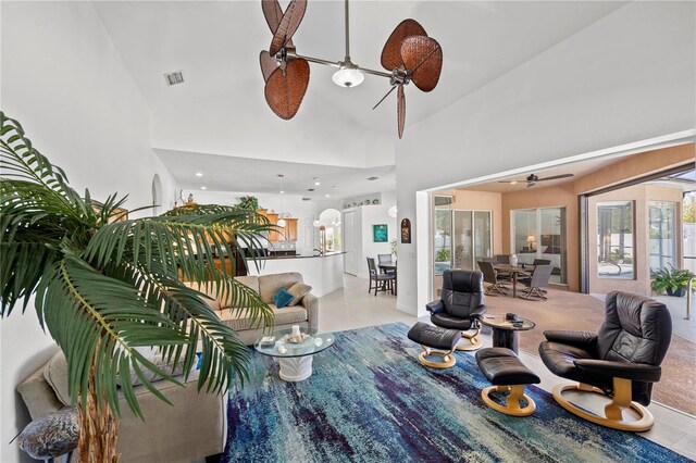 tiled living room featuring french doors, ceiling fan, and high vaulted ceiling