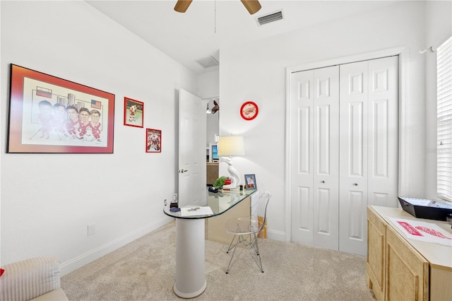 carpeted office with ceiling fan