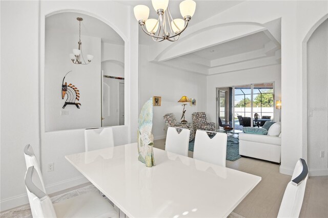 dining space with an inviting chandelier and light hardwood / wood-style floors