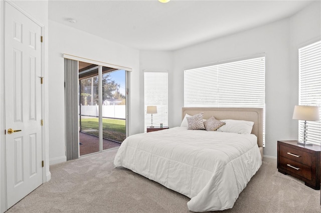 carpeted bedroom with access to exterior