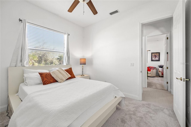 bedroom with light carpet and ceiling fan