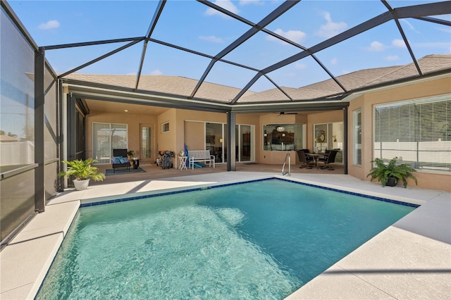 view of pool with a patio, a lanai, and ceiling fan