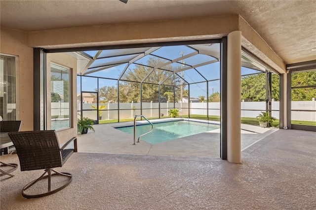 view of pool with a patio and glass enclosure