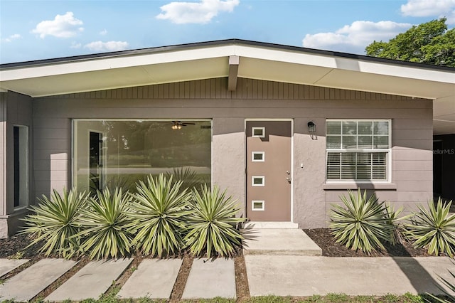 property entrance with stucco siding