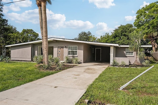 1642 Banyan Dr, Venice, FL 34293 - mid-century home with a carport, a front lawn, and concrete driveway