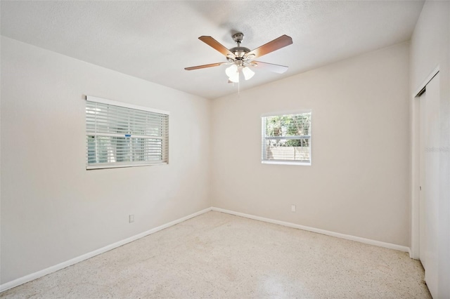 unfurnished bedroom featuring ceiling fan and a textured ceiling