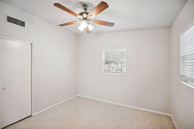 unfurnished bedroom featuring ceiling fan and a closet