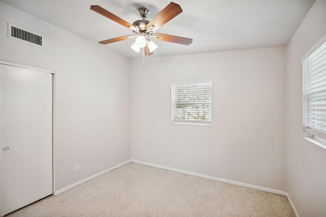 1642 Banyan Dr, Venice, FL 34293 - empty room with a ceiling fan, visible vents, baseboards, and speckled floor