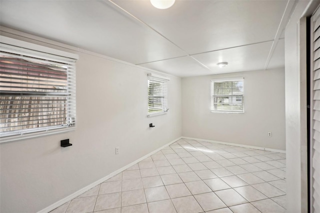 1642 Banyan Dr, Venice, FL 34293 - spare room with light tile patterned flooring and baseboards