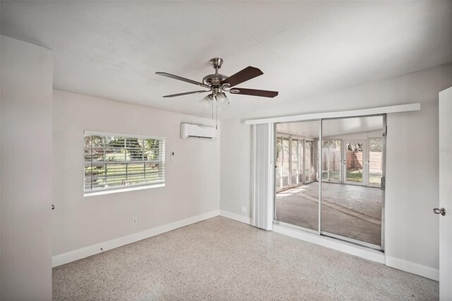 unfurnished room featuring ceiling fan, a wall mounted AC, and plenty of natural light