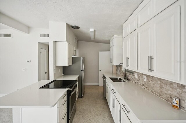 1642 Banyan Dr, Venice, FL 34293 - kitchen featuring visible vents, white cabinets, appliances with stainless steel finishes, light countertops, and a sink