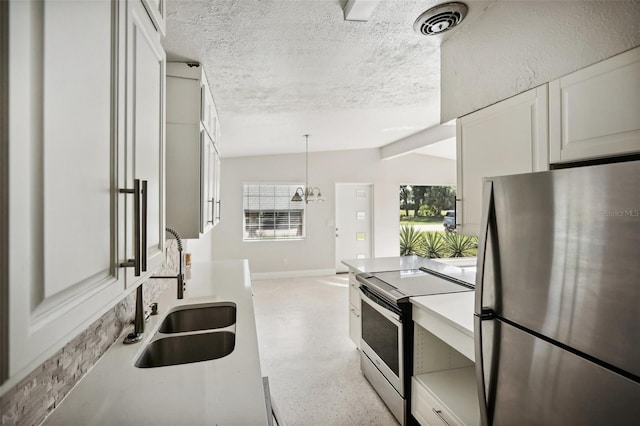 1642 Banyan Dr, Venice, FL 34293 - kitchen featuring visible vents, vaulted ceiling, a textured ceiling, stainless steel appliances, and a sink