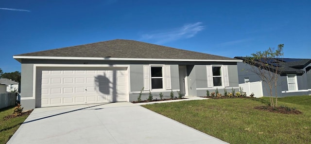 view of front of property with a front lawn and a garage