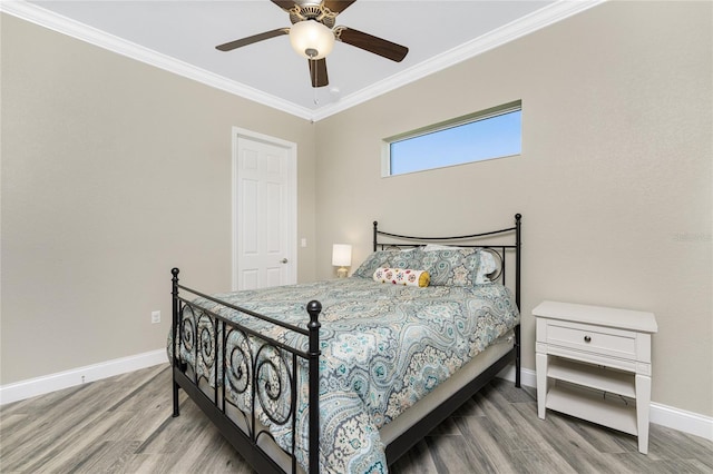 bedroom with ceiling fan, ornamental molding, and wood-type flooring