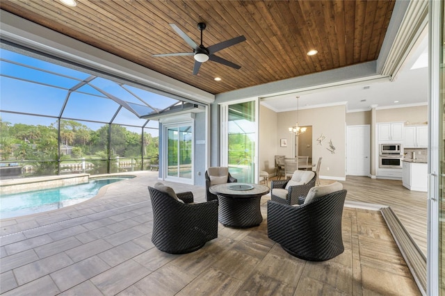 view of patio with a lanai and an outdoor living space with a fire pit