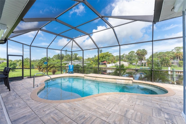 view of pool with a lanai, a patio, and a water view