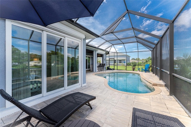 view of swimming pool with a patio and glass enclosure