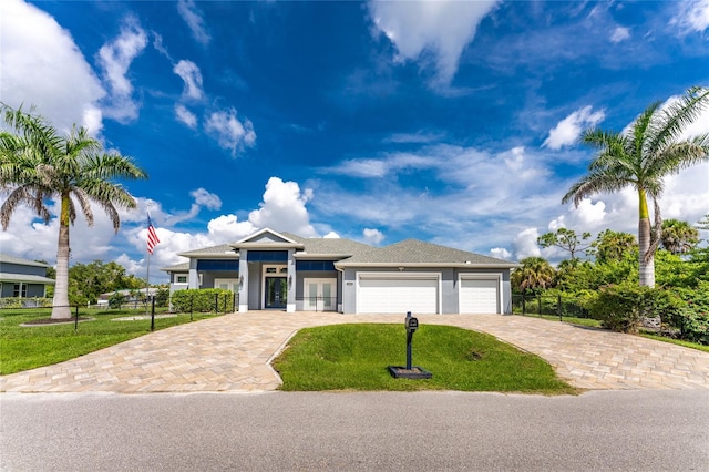 view of front of house with a garage and a front yard