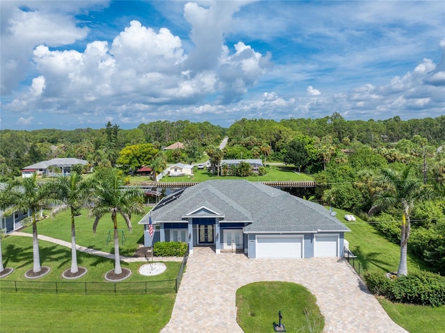 view of front of property with a garage and a front yard