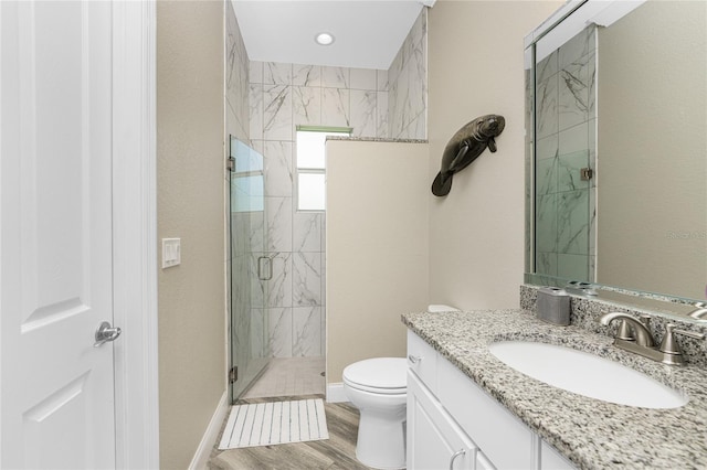 bathroom featuring hardwood / wood-style flooring, vanity, toilet, and walk in shower