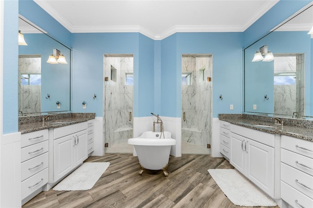 bathroom featuring ornamental molding, wood-type flooring, independent shower and bath, and vanity