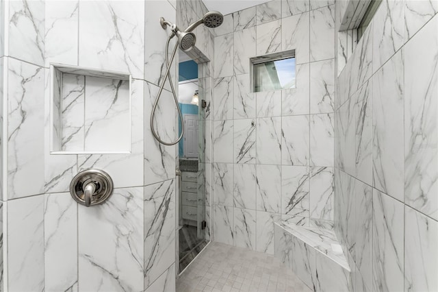 bathroom featuring a tile shower