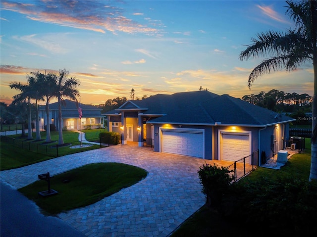 view of front facade with a garage and a lawn