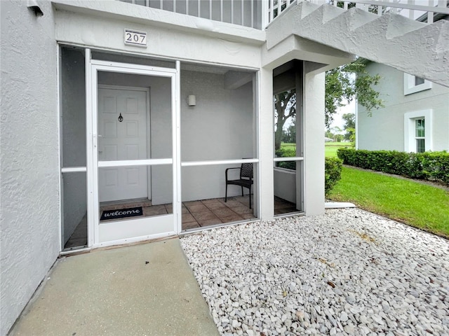 view of exterior entry featuring a patio area