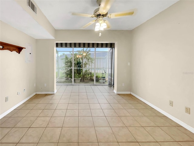 empty room featuring ceiling fan and light tile patterned floors