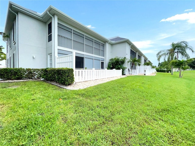 back of house with a lawn