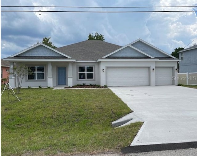 view of front of house with a garage and a front yard