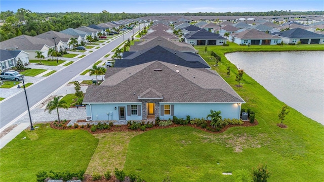 drone / aerial view featuring a water view and a residential view